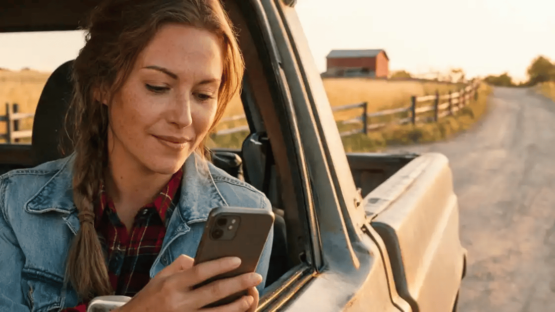 A rancher checks the live view on her phone
